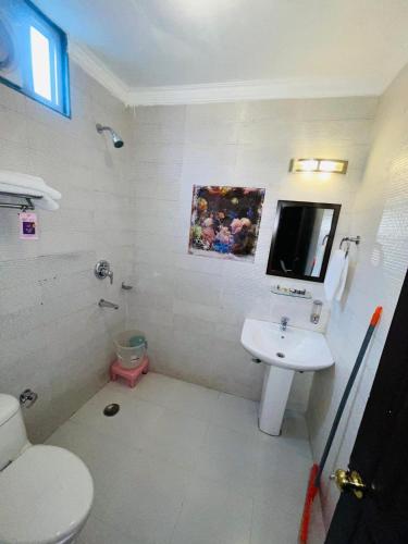 a bathroom with a toilet and a sink at Upper city heart hotel #Atithi Devo Bhava #Mountain View # Cheap Hotel Best Prices Guaranteed with Deals#Free Parking#cricket stadium 8 km#Mcleodganj 2 km- Bhagsunag 4 km in Dharamshala