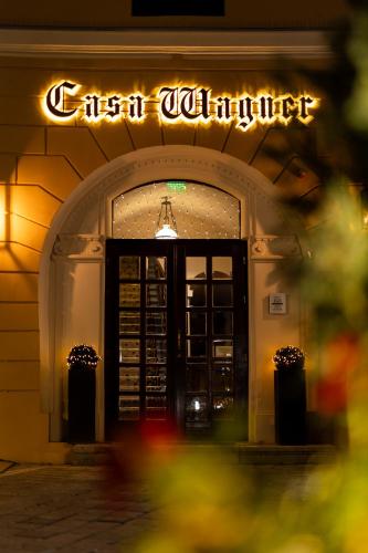 an entrance to a restaurant with a sign above the door at Casa Wagner in Braşov