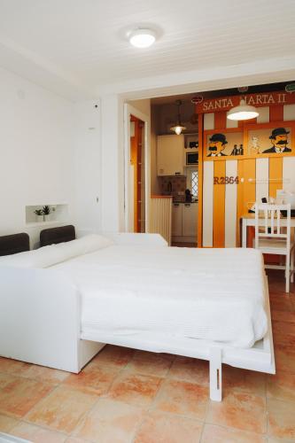 a large white bed in a room with a kitchen at Cencibel - Harbor's Light in Villajoyosa