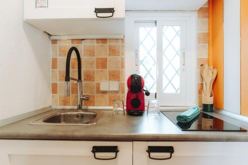 a kitchen counter with a sink and a window at Cencibel - Harbor's Light in Villajoyosa