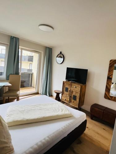 a bedroom with a bed and a flat screen tv at Apartment Gastein 3 in Bad Gastein