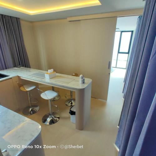 a room with a white table and two stools at Luxtalay Space Capsule in Ban Thung Makham