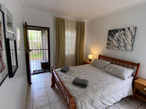 a bedroom with a bed with a suitcase on it at Manasseh in Riversdale