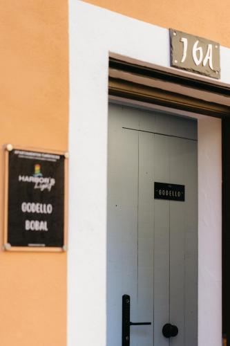 a door to a building with a sign on it at Godello - Harbor's Light in Villajoyosa