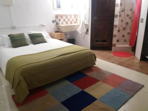 a bedroom with a bed and a colorful rug at The office 2020 in Tres Cantos