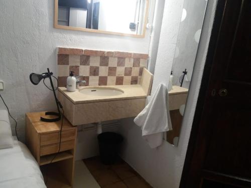 a bathroom with a sink and a mirror at The office 2020 in Tres Cantos