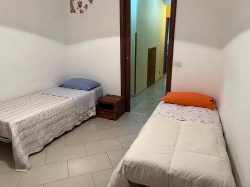 a bedroom with two beds and a mirror at Cassiopea in Isnello