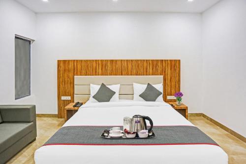 a hotel room with a bed with a coffee maker on a tray at Townhouse Super Two Premium in Varanasi