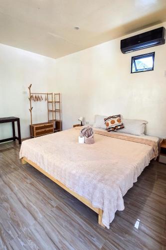 a bedroom with a large bed in a room at Coconut El Nido in El Nido