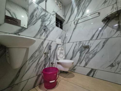 a bathroom with a toilet and a sink at EVA AYURVEDIC beach hotel in Varkala