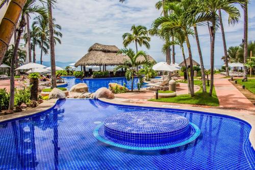 a pool at the resort at Plaza Pelicanos Grand Beach Resort All Inclusive in Puerto Vallarta