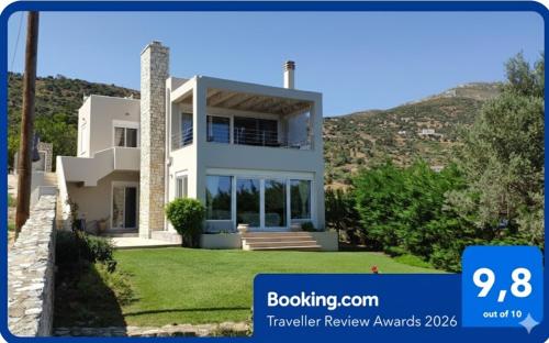 a house with a mountain in the background at Villa with Aegean views in Akhladherí