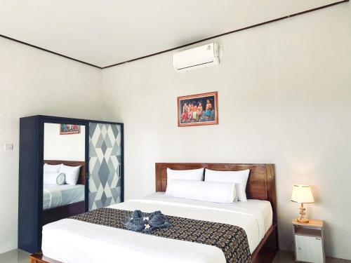 a bedroom with two beds with cats sitting on them at Winners surfing bali resort in Airsatang