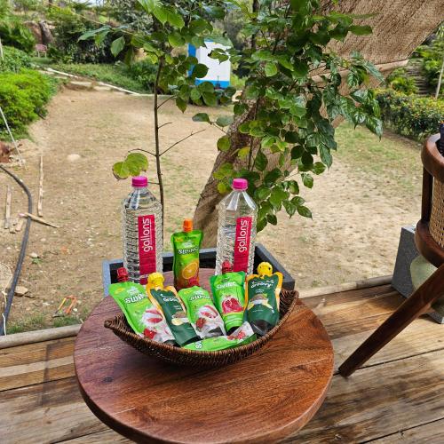 a basket of soda and snacks on a table at Aaryavan, A boutique resort in Mount Ābu