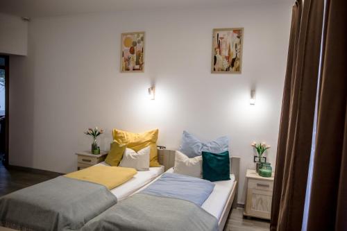 two beds sitting next to each other in a room at Hont Vendégház in Hont
