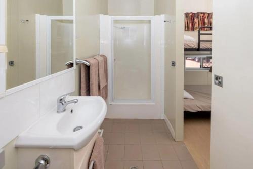 a bathroom with a sink and a mirror at BIG4 Opal Holiday Park in Lightning Ridge