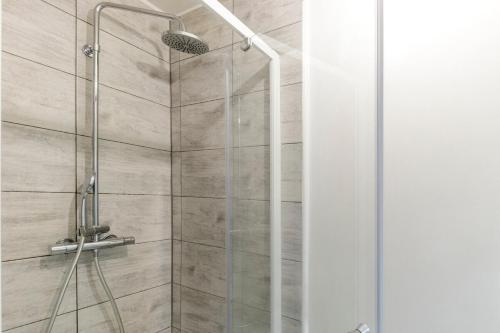 a shower stall with a glass door in a bathroom at Cœur Historique, Duplex pour 5 in Issoudun
