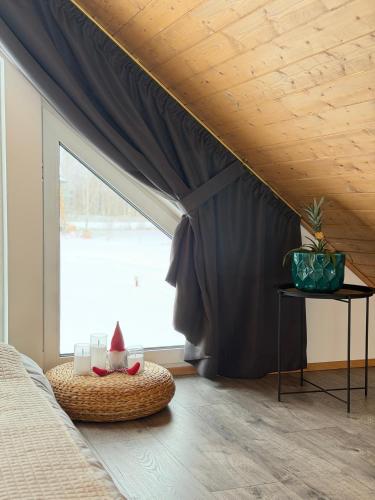 a bedroom with a bed and a window with curtains at REAL House in Vītoliņi