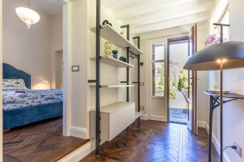 a room with a bed and a room with a staircase at Lo Studiolo Fiesole in Fiesole