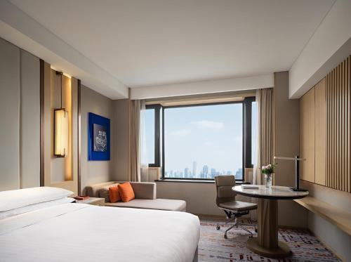 a hotel room with two beds and a table at Renaissance Shanghai Hongqiao in Shanghai