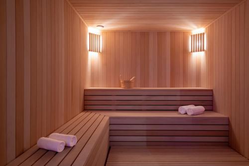 a sauna with two towels on a wooden bench at Ambassadori Goderdzi Hotel in Goderdzi