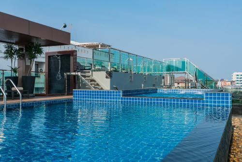 a swimming pool with blue tiles on the side of a building at Acqua Hotel in Pattaya
