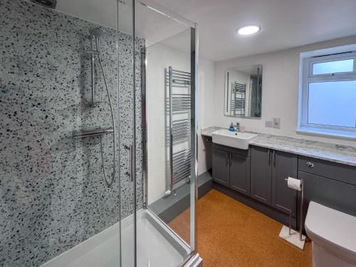 a bathroom with a shower and a sink at Arcadia Cottage, Mere in Mere