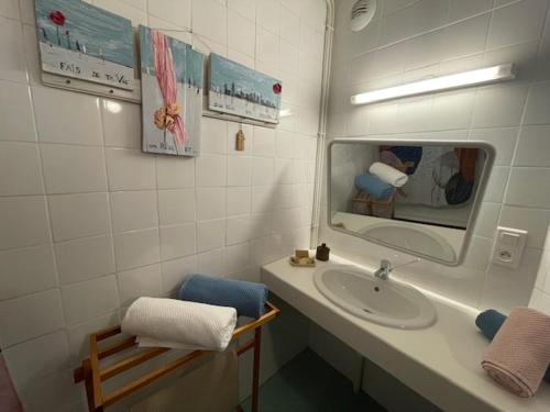 a bathroom with a sink and a mirror at Le Matagot Auberge-Restaurant in Mazeyrat-Aurouze