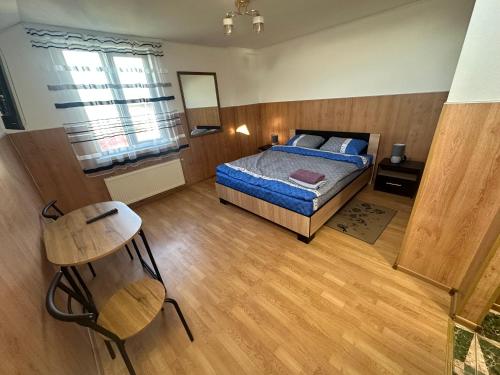 a bedroom with a bed and a chair in it at Бордуляка 11 in Ternopil