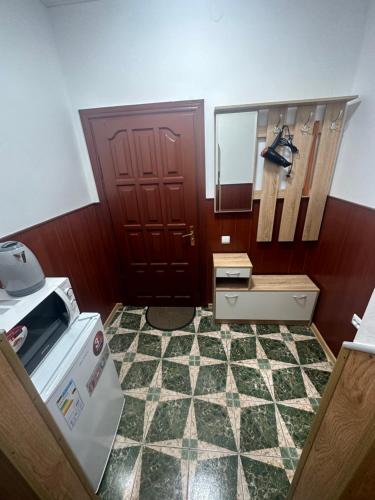 a room with a door and a sink and a stove at Бордуляка 11 in Ternopil