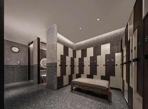 a locker room with a bench and a clock at Renaissance Shanghai Hongqiao in Shanghai