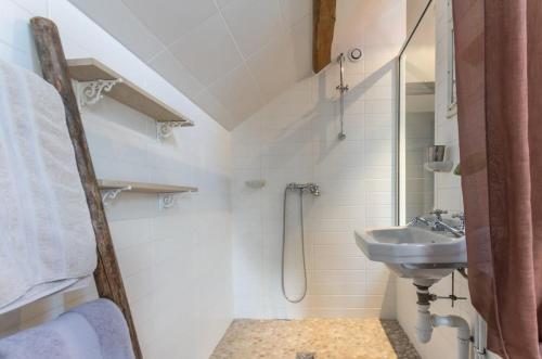 a white bathroom with a sink and a shower at Le P'tit Clos in Vantoux