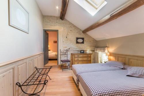 a bedroom with two beds and a dresser in it at Le P'tit Clos in Vantoux