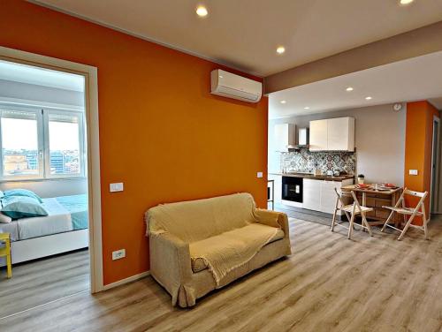 a living room with a couch and a kitchen at Garba Stop in Rome