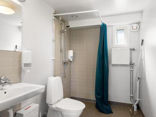 a bathroom with a toilet and a sink and a shower at First Camp Västerås-Mälaren in Västerås