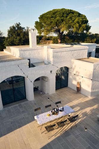 an overhead view of a building with a table and chairs at Masseria Pietra e Terra in Carovigno