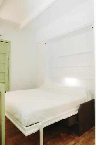 a bed in a room with a white bed frame at Prieto Picudo - Harbor's Light in Villajoyosa