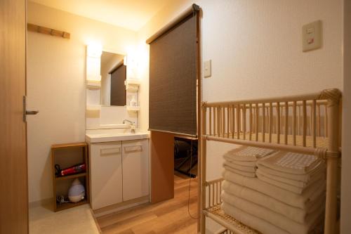 a baby room with a crib and a sink at NIYS apartments 01 type in Tokyo