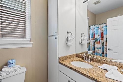 a bathroom with a sink and a mirror at Destiny Beach Villas #9A in Destin