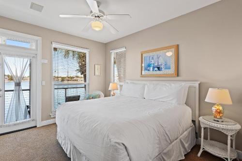 a bedroom with a white bed and a window at Destiny Beach Villas #9A in Destin