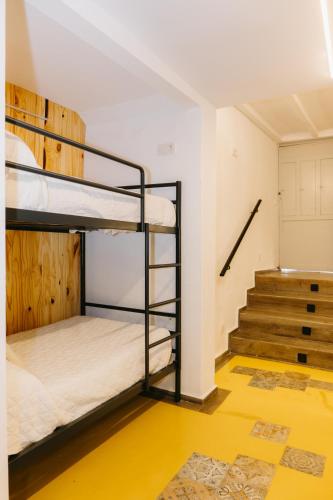 a room with two bunk beds and a staircase at Lambrusco - Harbor's Light in Villajoyosa