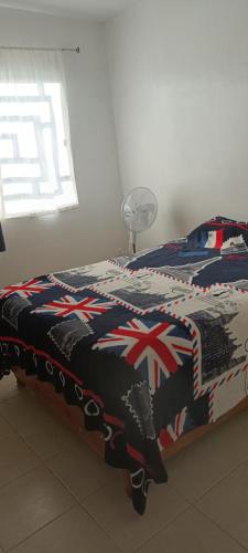 a bed in a room with a british blanket at Paseo San Andres in Zacatecas