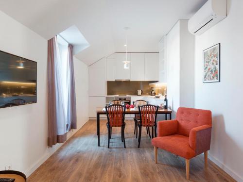 a kitchen and dining room with a table and chairs at LSA Restauradores by Numa in Lisbon