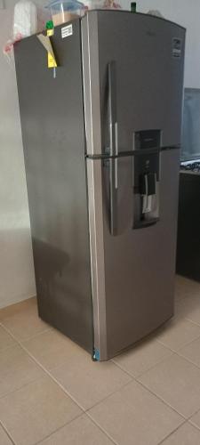 a stainless steel refrigerator sitting in a kitchen at Paseo San Andres in Zacatecas