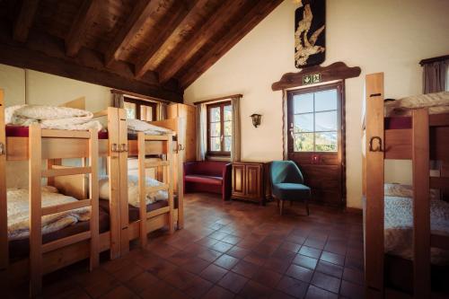 a room with a bunch of bunk beds in it at Grünsee Mountain Lodge in Zermatt