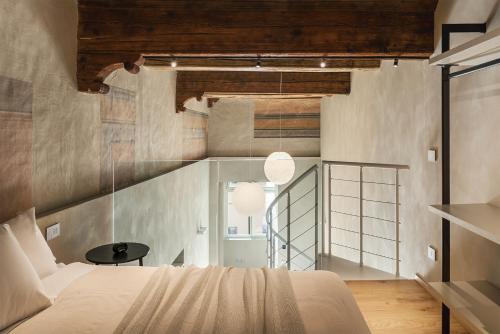 a bedroom with a bed and a glass wall at Dimora Beggiami by Vayadù in Savigliano