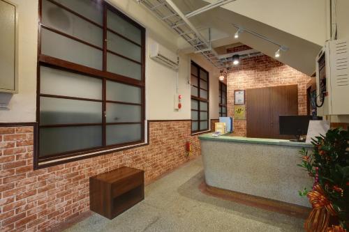 a bar in an office with a brick wall at DC Hotel in Taichung