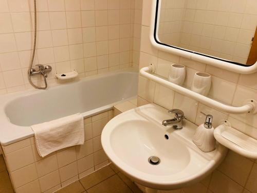 a bathroom with a sink and a bath tub at Dolní Náměstí in Rokytnice nad Jizerou
