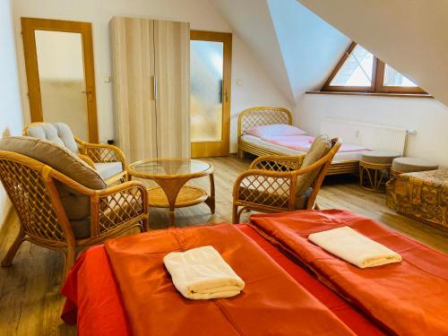 a living room with two beds and chairs at Dolní Náměstí in Rokytnice nad Jizerou