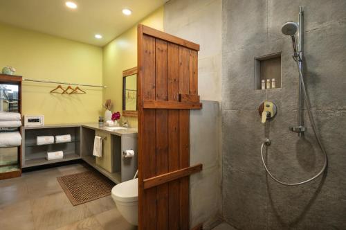 a bathroom with a shower and a toilet at SaffronStays Vinayalam in Mahabaleshwar